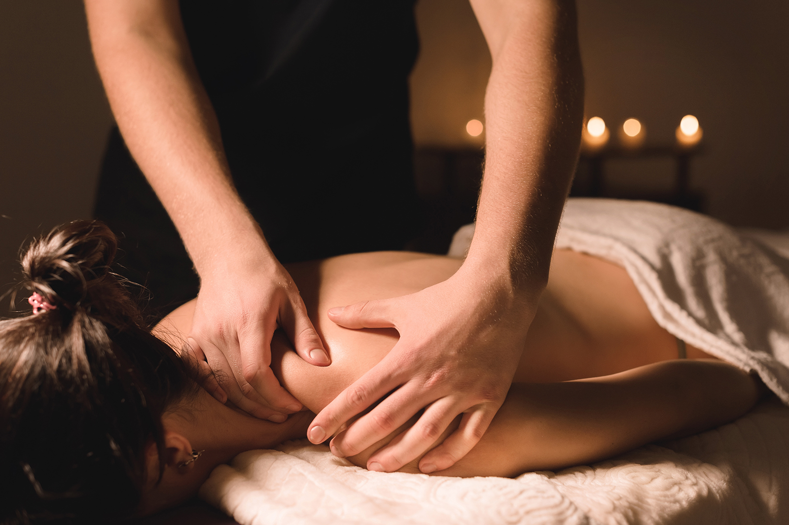 Massage therapist performing deep tissue massage